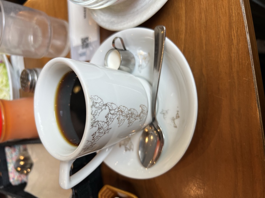 Black coffee in a world-map cup at a cafe
