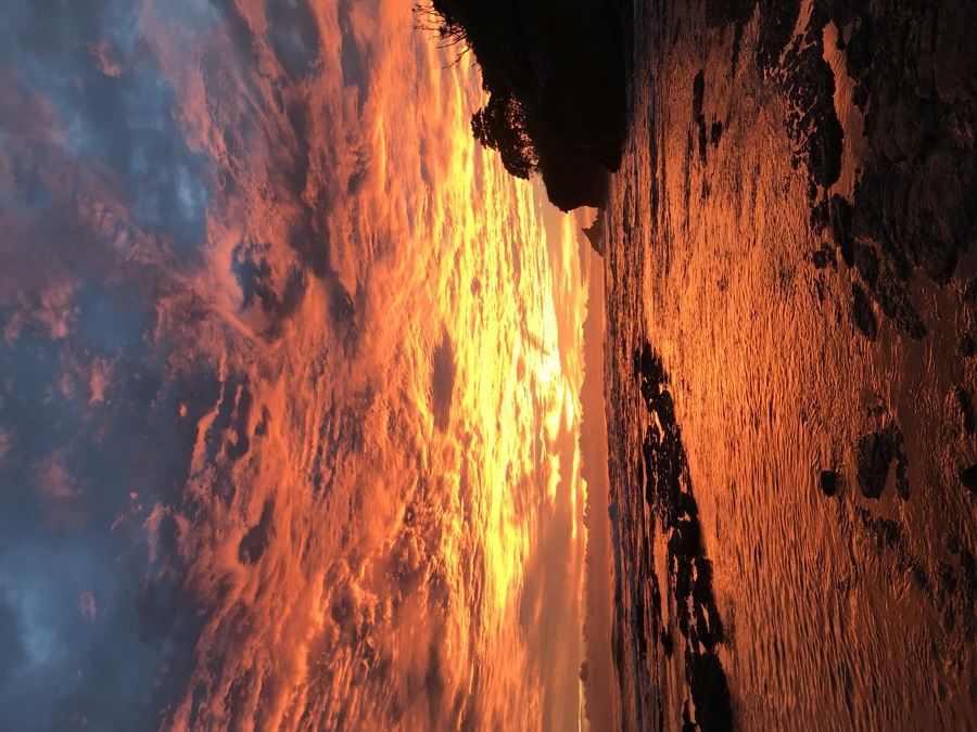 Fiery sunset over the rocky Pacific coastline at Nosara
