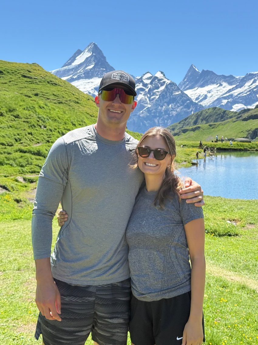 In front of an alpine lake below snow-capped peaks near Grindelwald
