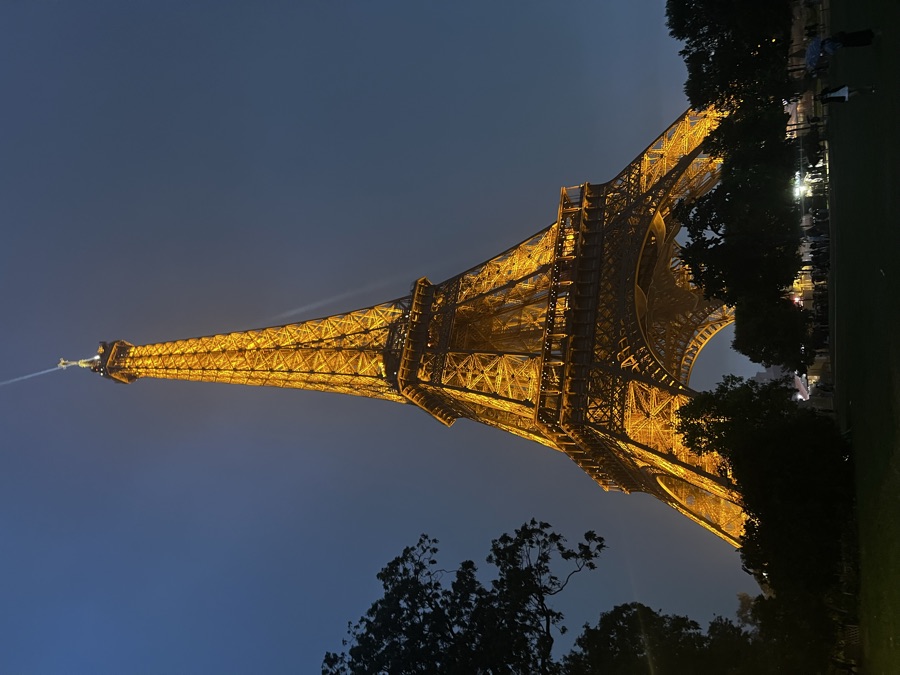 The Eiffel Tower lit up gold at night in Paris